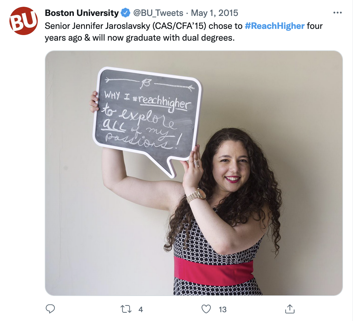 A picture of a tweet with a custom photo. In it, a white woman with curly black hair holds a speech bubble shaped chalkboard reading &ldquo;Why I reach higher: to explore all of my passions!&rdquo;.